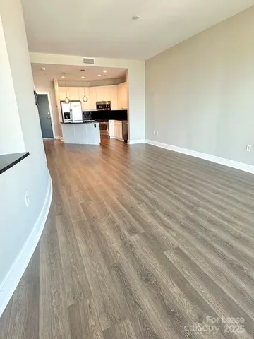 a view of a living room with hardwood floor