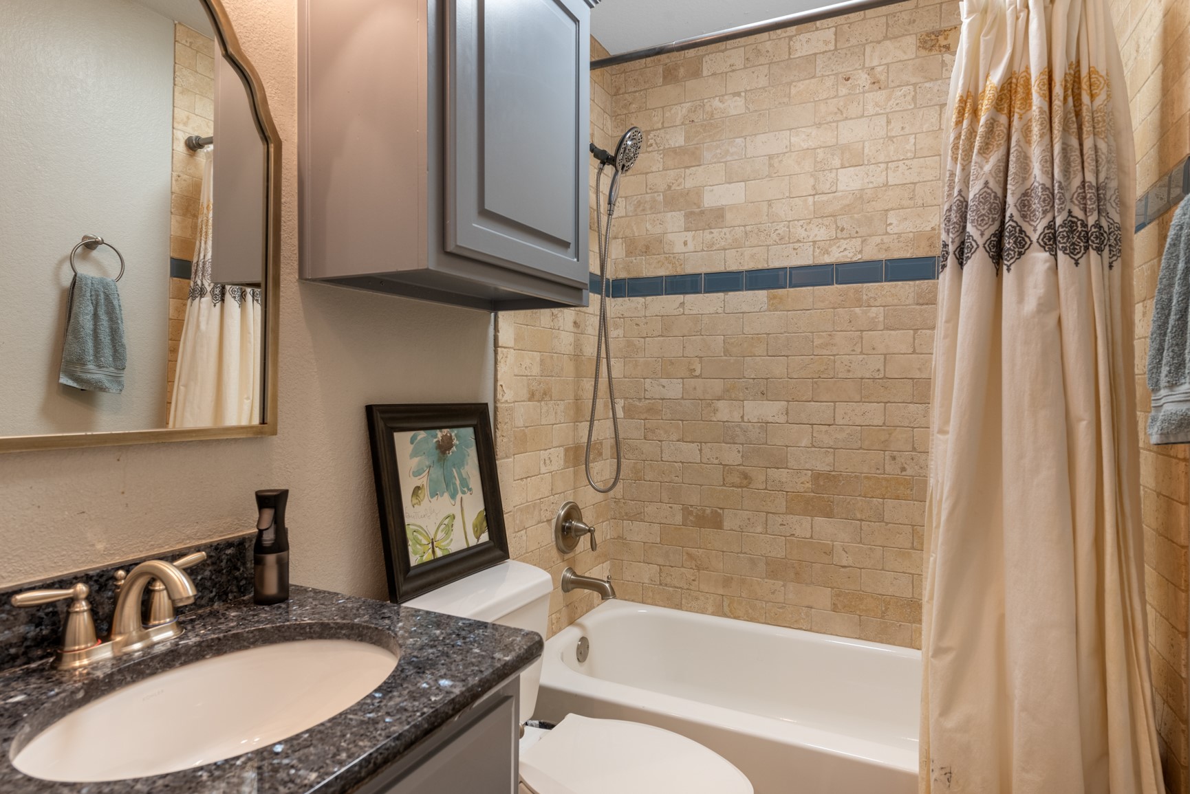 664 Ranchers Club Lane, Unit 1 Driftwood, TX 78619 - Photo 19 of 40 a bathroom with a granite countertop sink mirror vanity and a bathtub