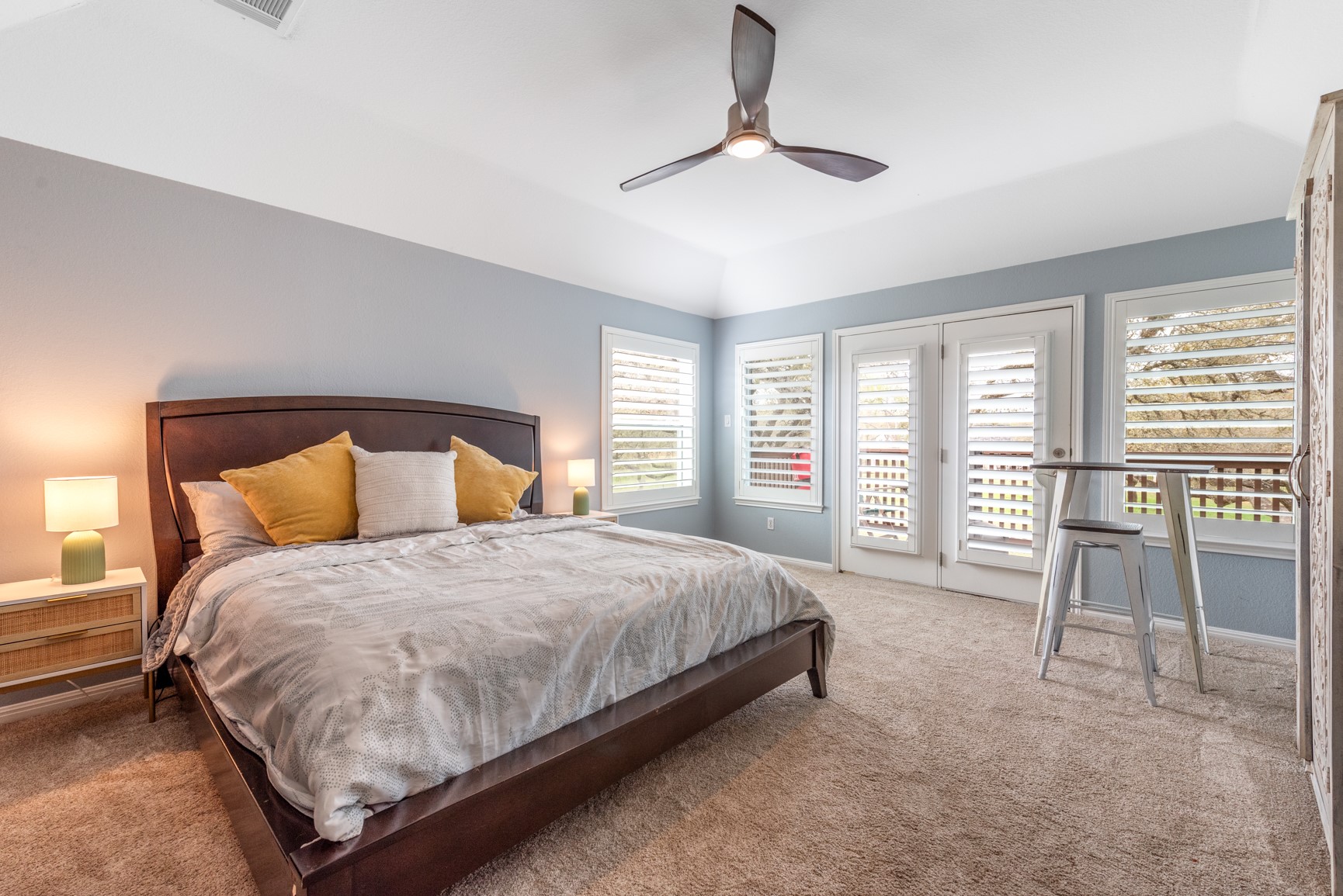 664 Ranchers Club Lane, Unit 1 Driftwood, TX 78619 - Photo 20 of 40 a bedroom with a bed a table and chair