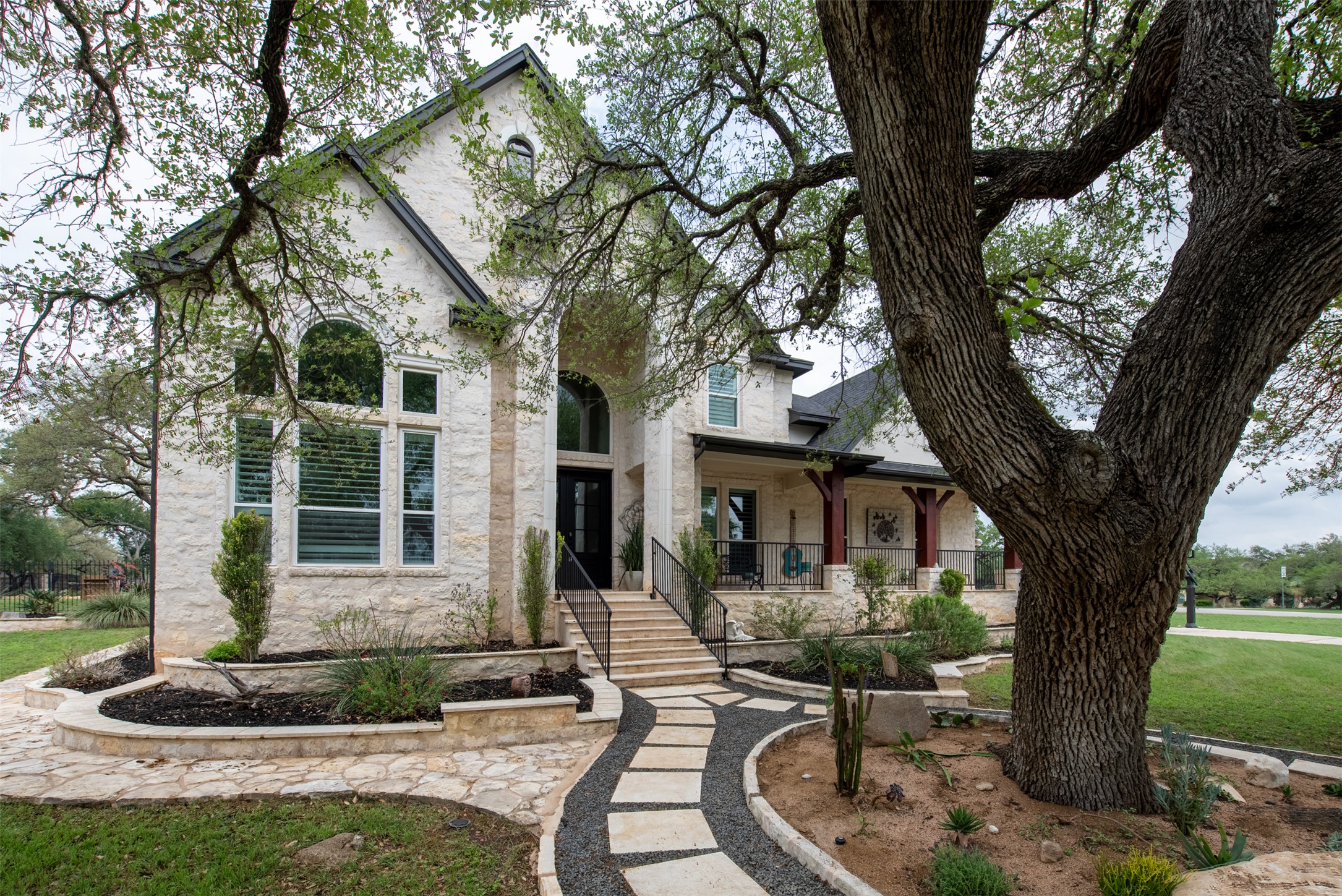 664 Ranchers Club Lane, Unit 1 Driftwood, TX 78619 - Photo 2 of 40 a front view of a house with garden and trees