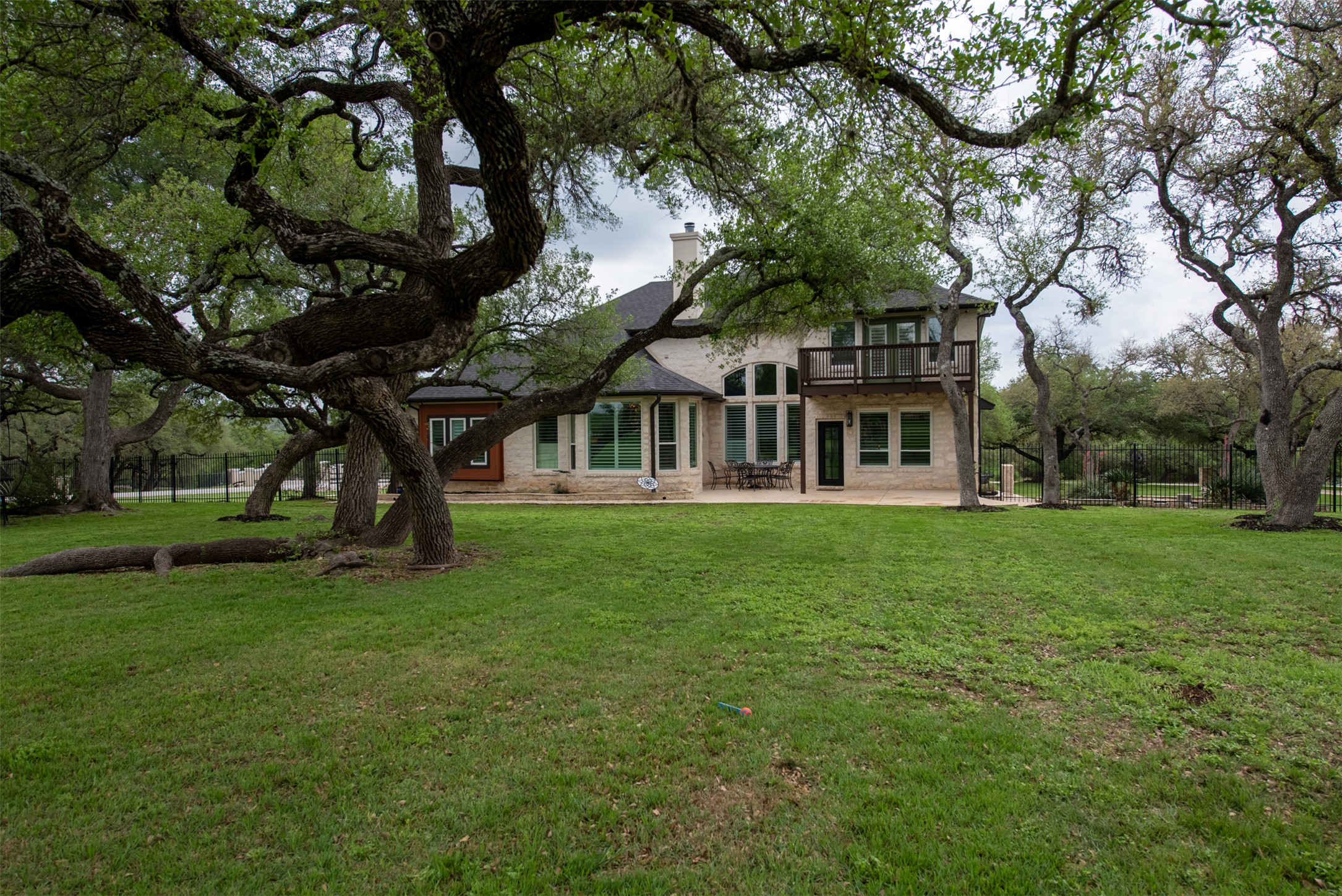 664 Ranchers Club Lane, Unit 1 Driftwood, TX 78619 - Photo 28 of 40 a front view of a house with a garden