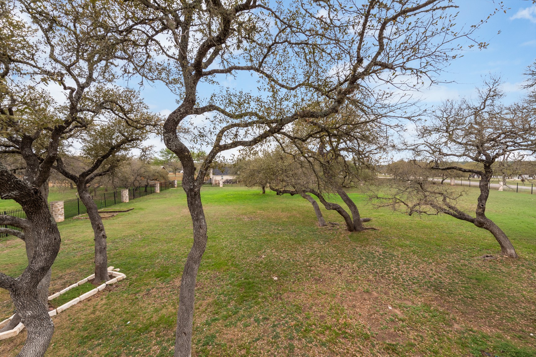 664 Ranchers Club Lane, Unit 1 Driftwood, TX 78619 - Photo 29 of 40 a backyard of a house with lots of green space