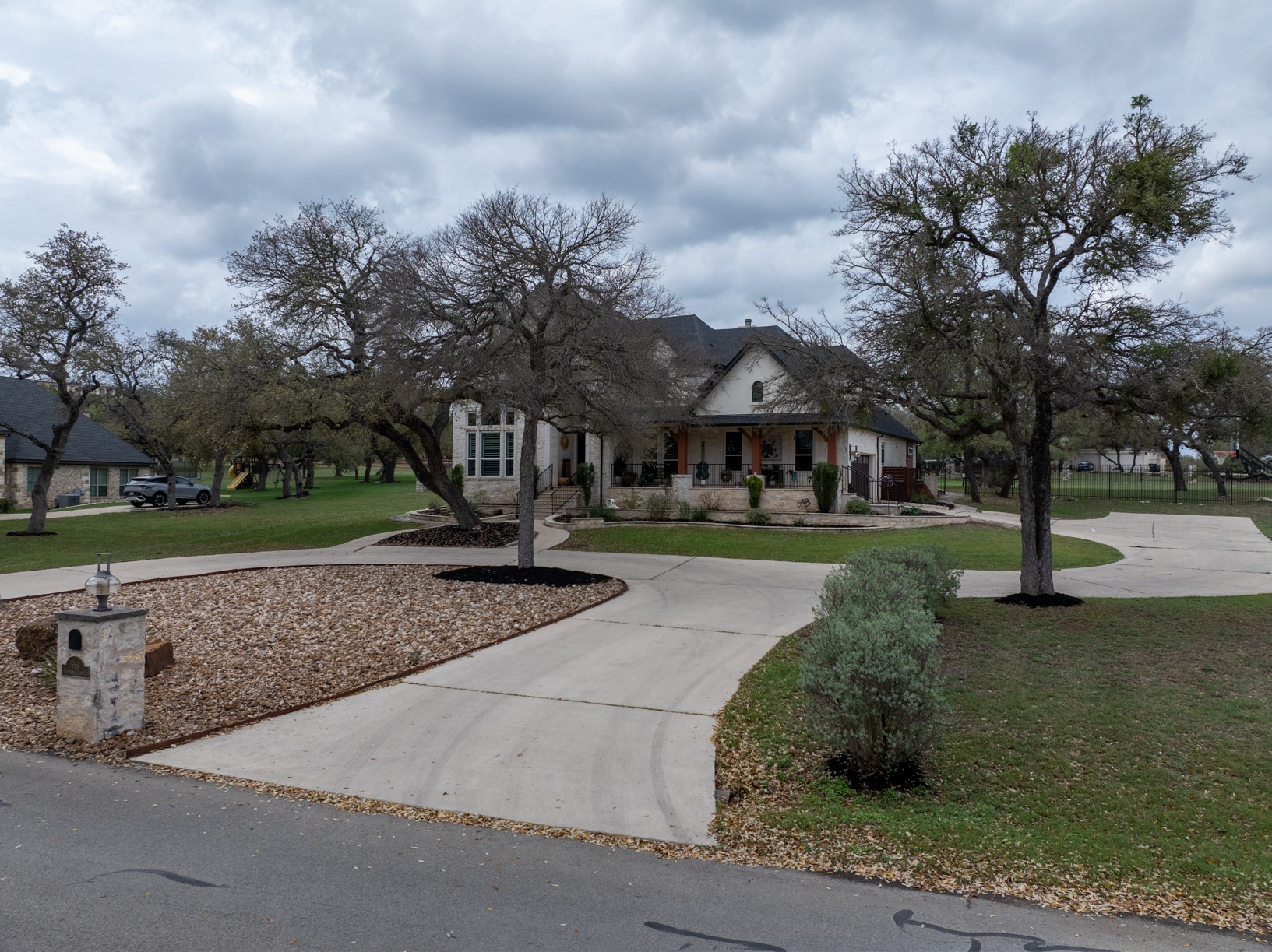 664 Ranchers Club Lane, Unit 1 Driftwood, TX 78619 - Photo 40 of 40 a front view of a house with garden and trees