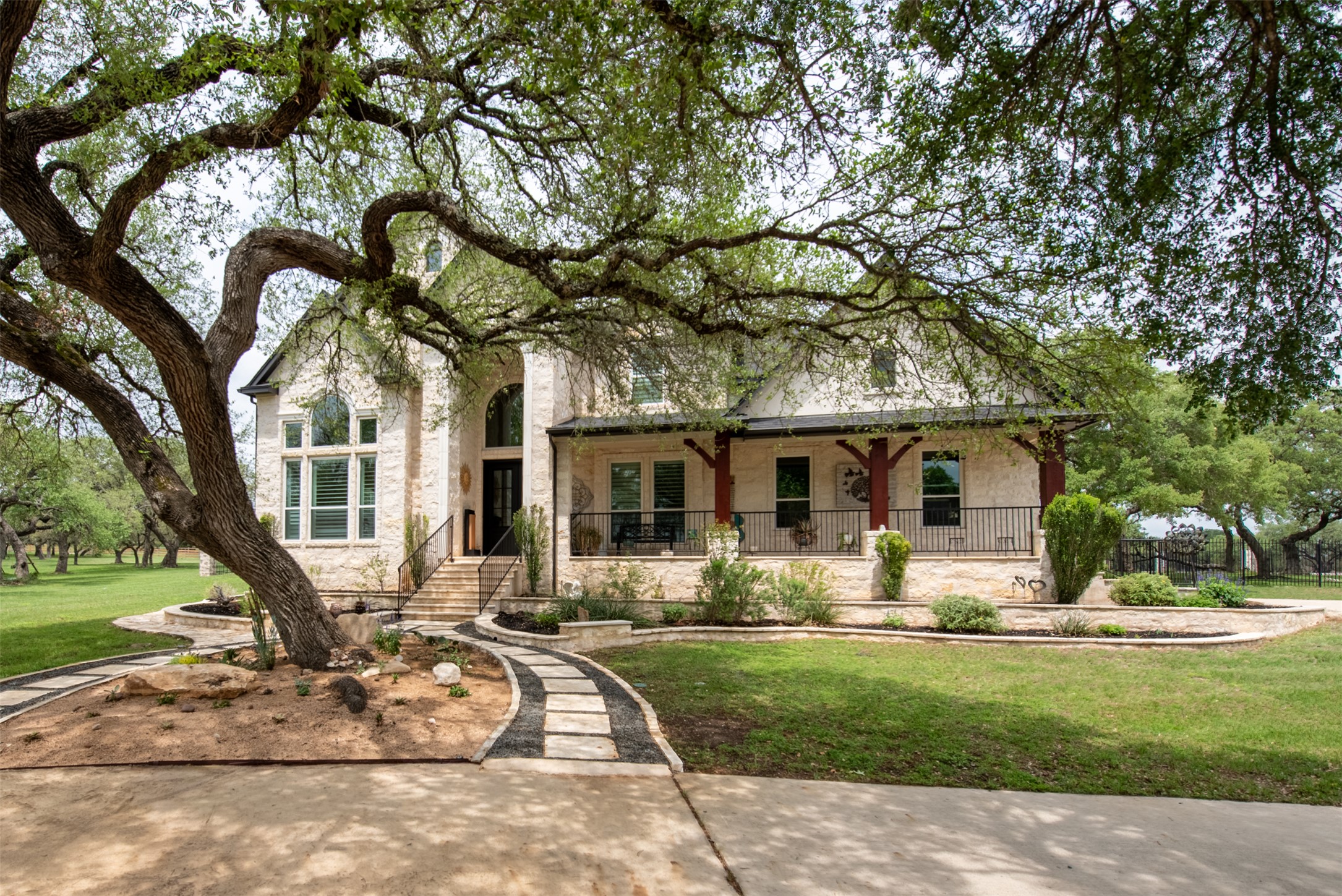664 Ranchers Club Lane, Unit 1 Driftwood, TX 78619 - Photo 4 of 40 a front view of a house with garden