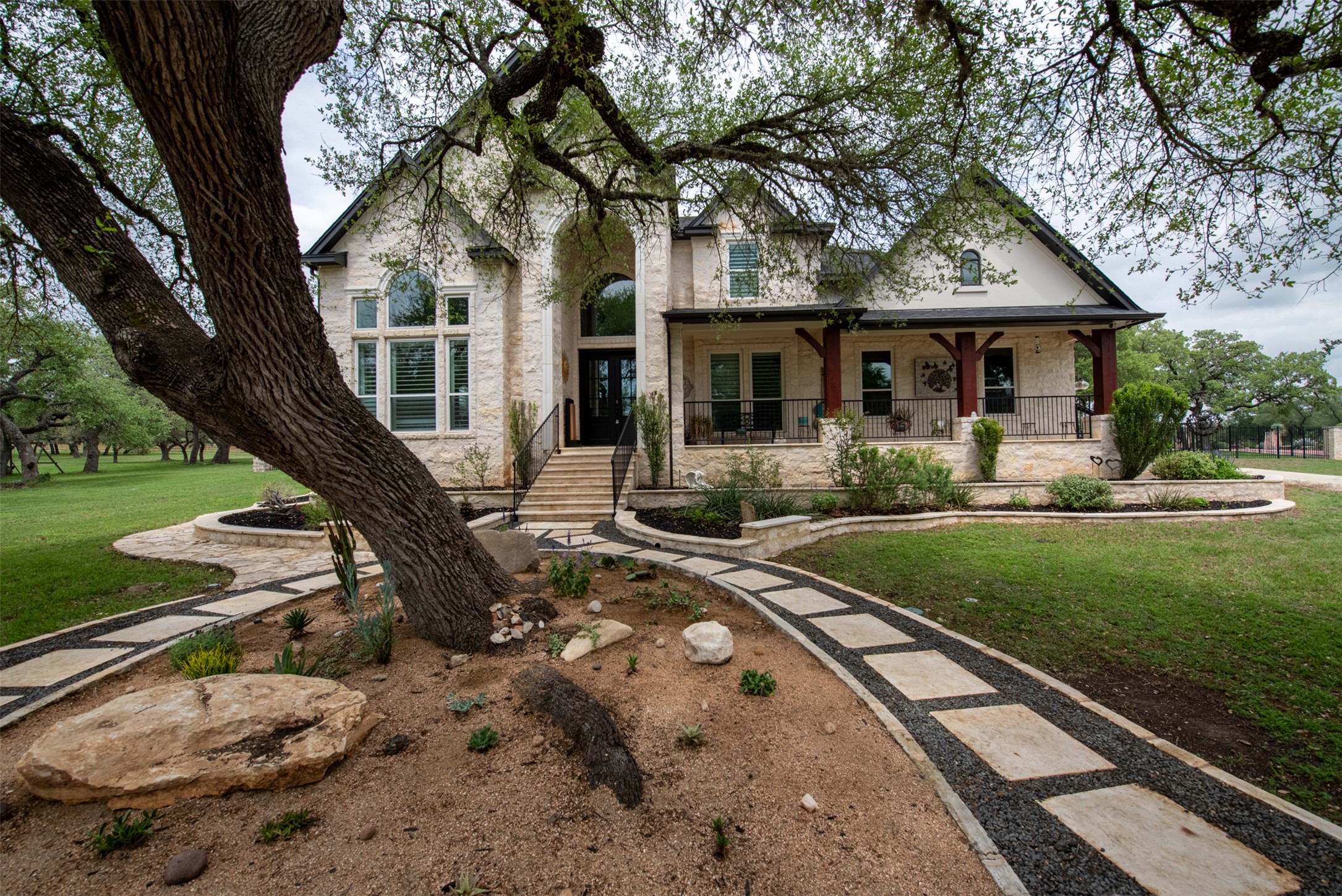 664 Ranchers Club Lane, Unit 1 Driftwood, TX 78619 - Photo 5 of 40 a front view of a house with yard green space and outdoor seating