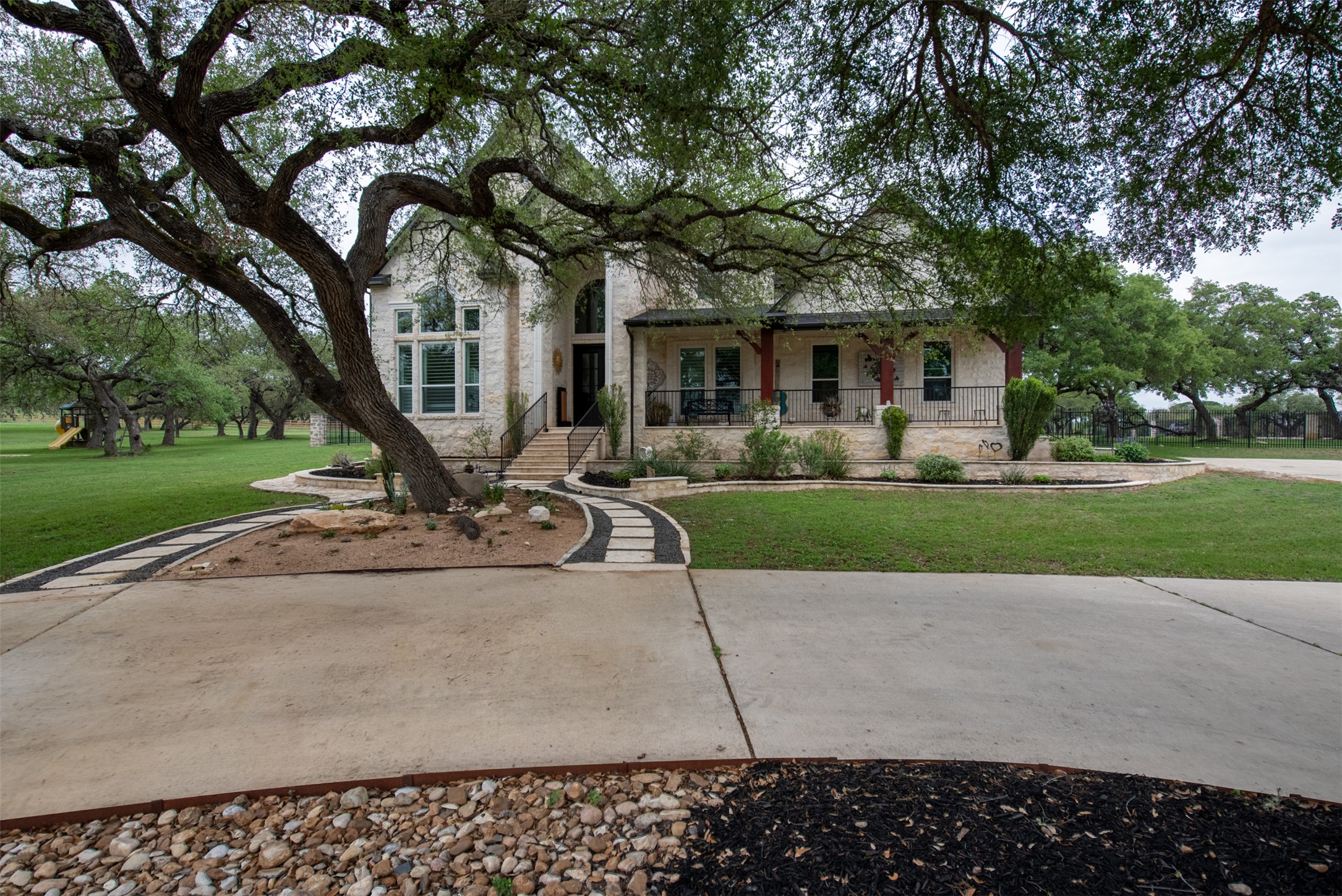 664 Ranchers Club Lane, Unit 1 Driftwood, TX 78619 - Photo 6 of 40 a view of a house with a garden