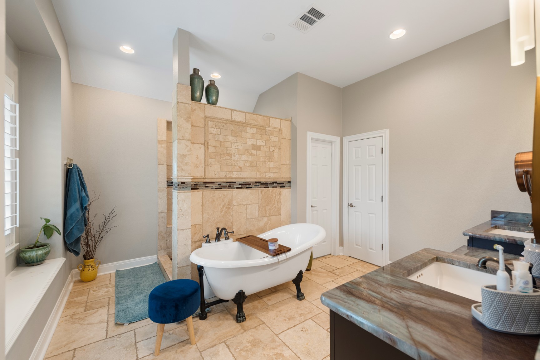 664 Ranchers Club Lane, Unit 1 Driftwood, TX 78619 - Photo 10 of 40 a spacious bathroom with a granite countertop sink a toilet and a mirror