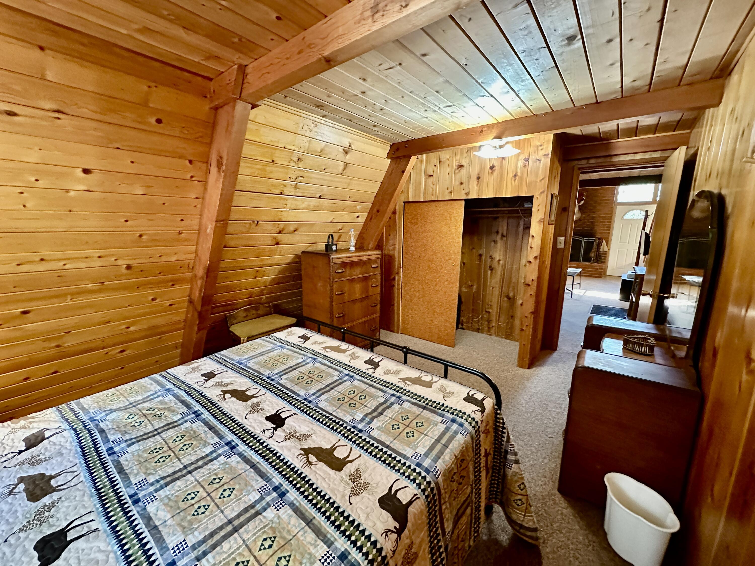 24560 Upper Rim Rock Road Idyllwild, CA 92549 - Photo 22 of 56 a bed sitting in a bedroom next to a window