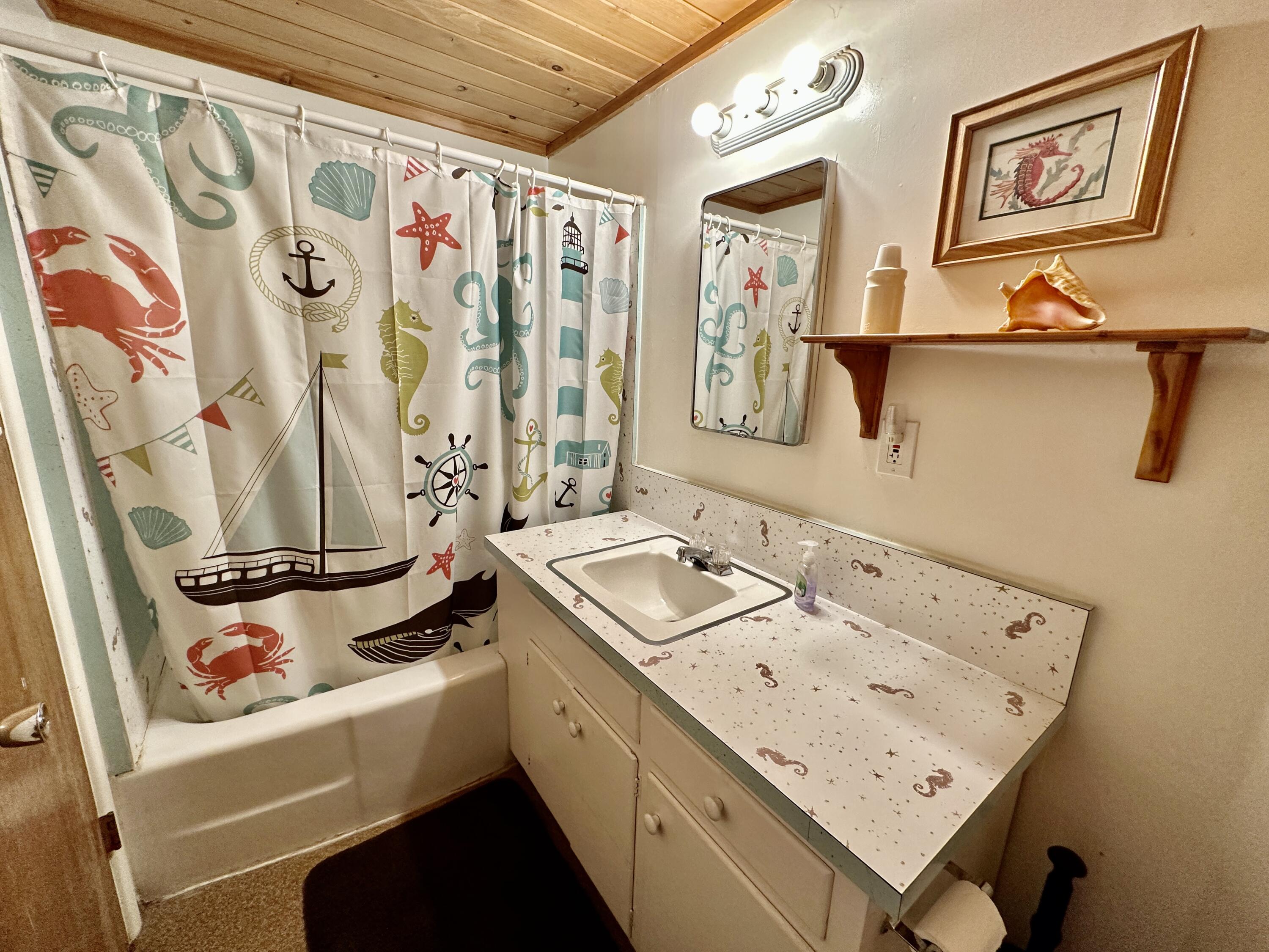 24560 Upper Rim Rock Road Idyllwild, CA 92549 - Photo 31 of 56 a bathroom with a sink a mirror and a shower curtain