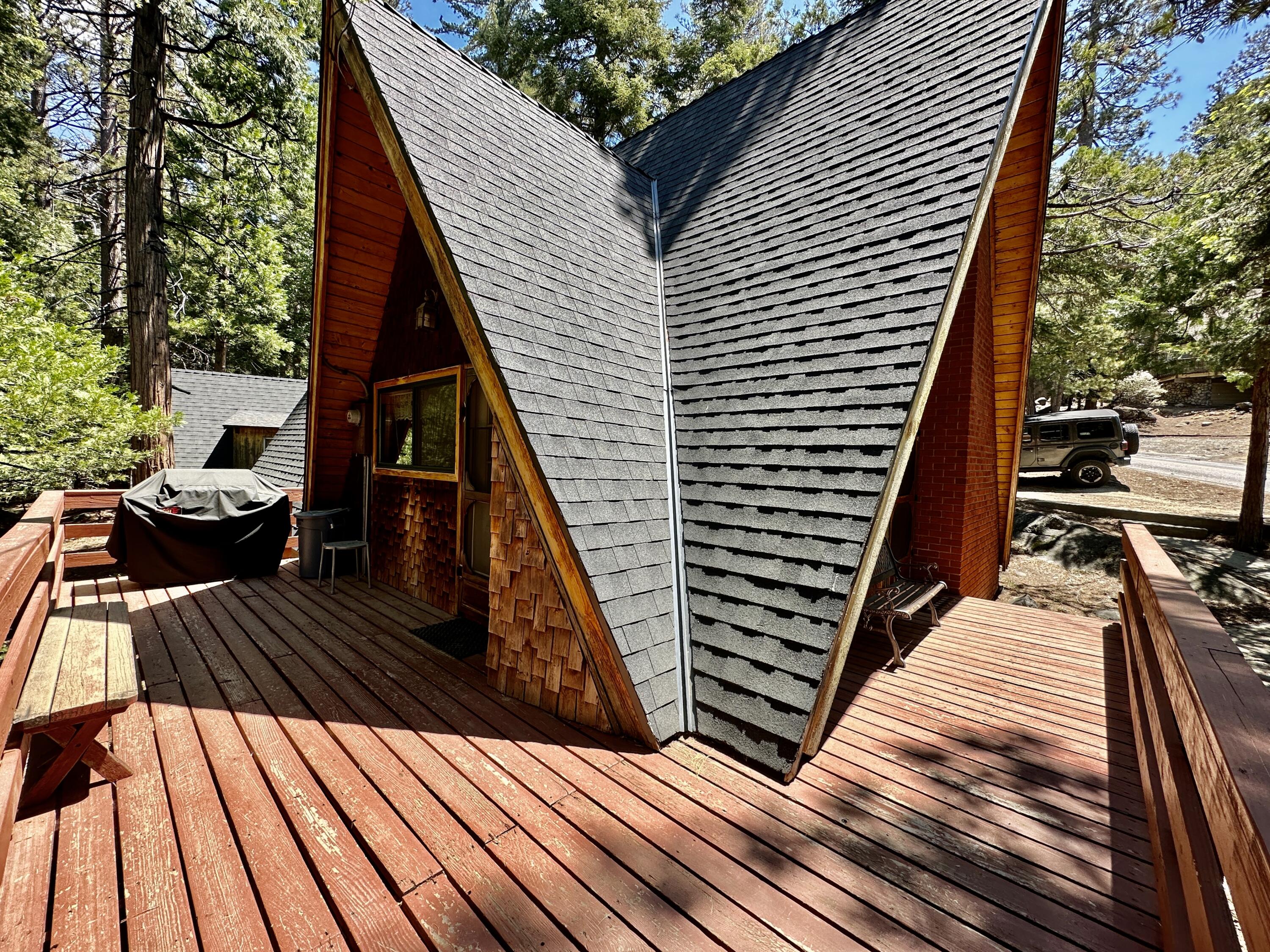 24560 Upper Rim Rock Road Idyllwild, CA 92549 - Photo 5 of 56 a view of deck with wooden floor and outdoor seating