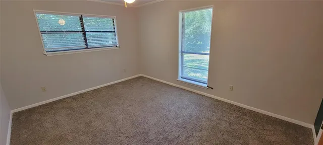 a view of staircase with lots of frames on wall and windows