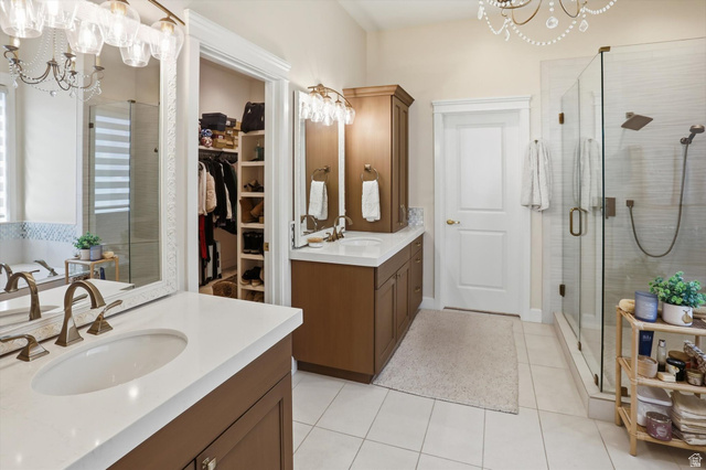 534 East Fish Hatchery Road Mantua, UT 84324 - Photo 46 of 87 Bathroom featuring suspended lighting, two vanities, a shower stall, and a spacious closet
