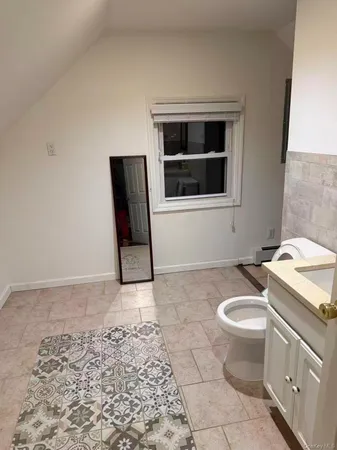 a bathroom with a sink toilet and mirror