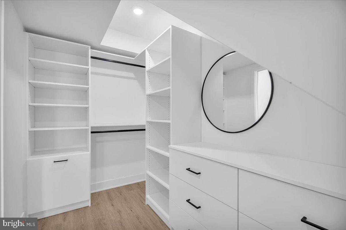 2615 East Boston Street, Unit 2 Philadelphia, PA 19125 - Photo 11 of 24 a bathroom with a mirror and a wooden floor