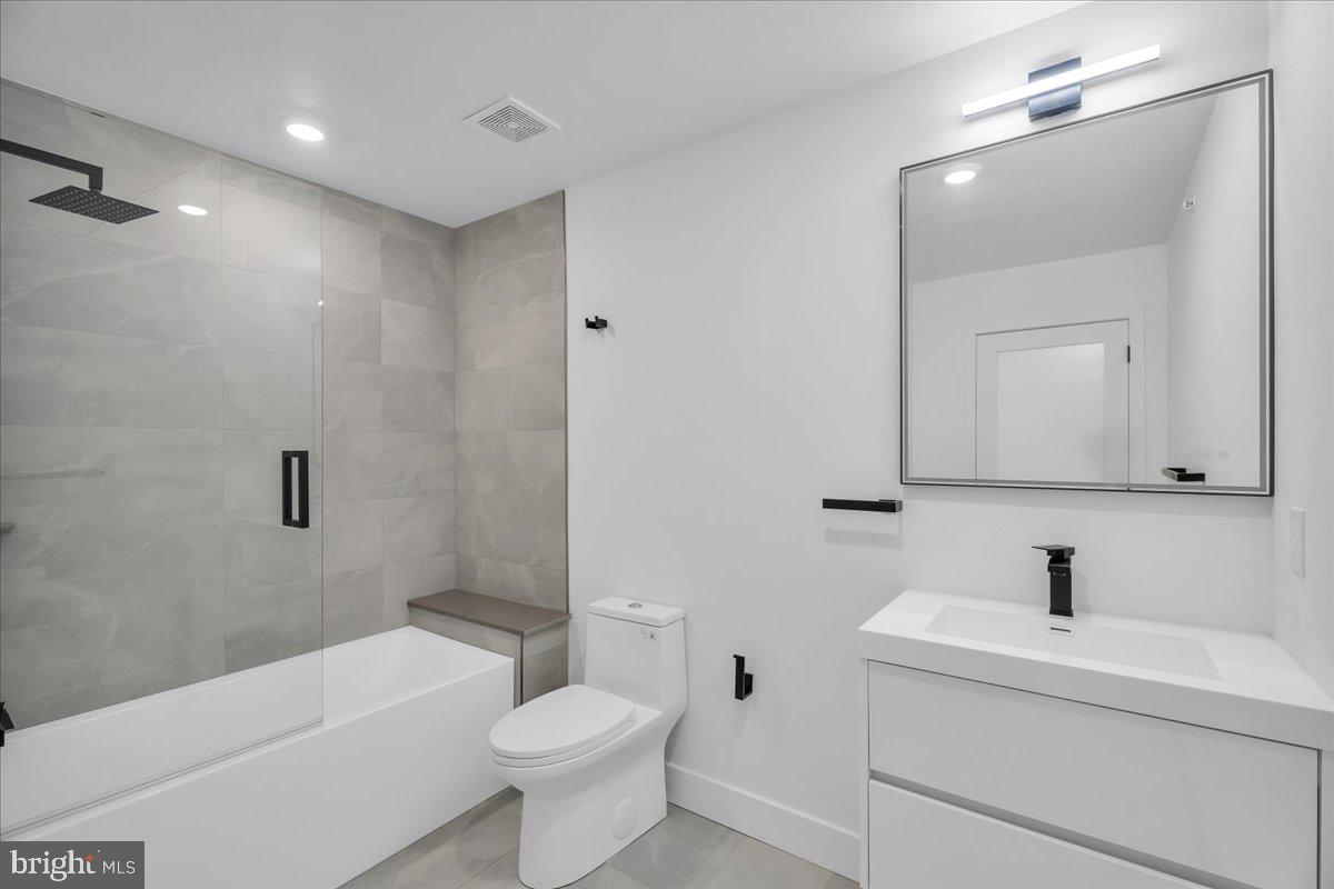 2615 East Boston Street, Unit 2 Philadelphia, PA 19125 - Photo 15 of 24 a bathroom with a toilet a sink a mirror and bathtub