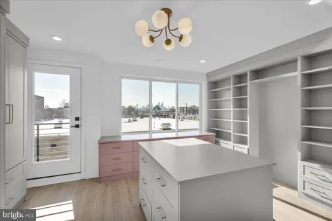 a view of a terrace with furniture and city view