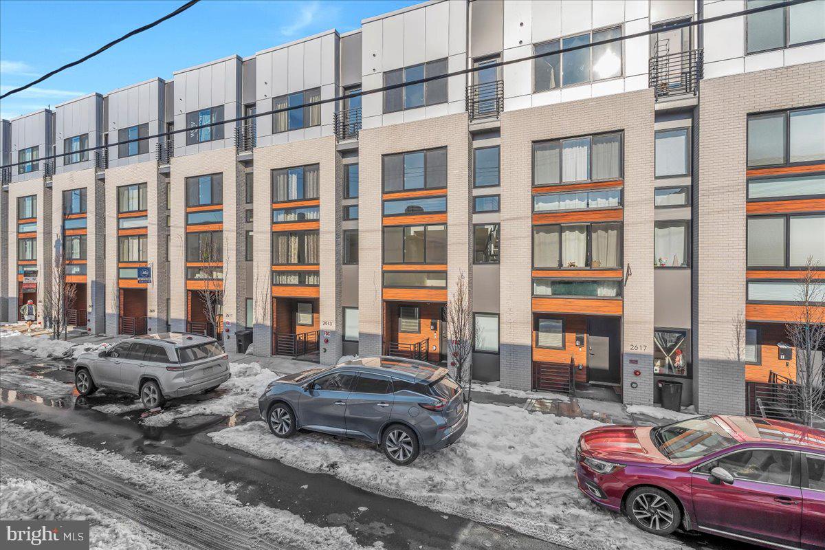 2615 East Boston Street, Unit 2 Philadelphia, PA 19125 - Photo 2 of 24 a car parked in front of a brick building