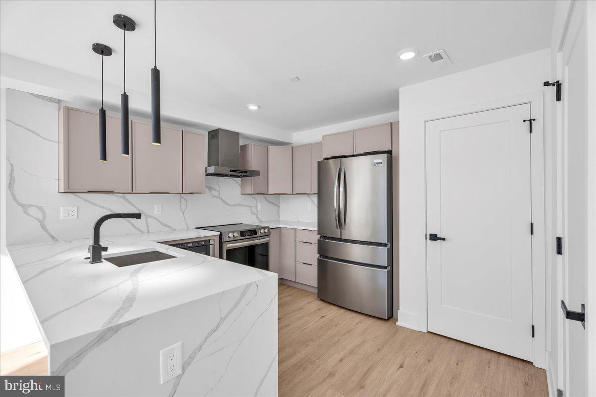 2615 East Boston Street, Unit 2 Philadelphia, PA 19125 - Photo 6 of 24 a kitchen with stainless steel appliances a refrigerator sink and wooden floor