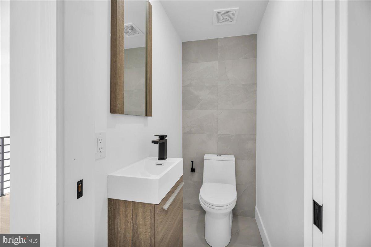 2615 East Boston Street, Unit 2 Philadelphia, PA 19125 - Photo 9 of 24 a white toilet sitting next to a bathroom sink