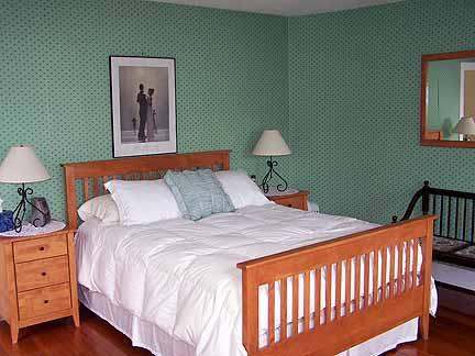 1180 Hawley Road Ashfield, MA 01330 - Photo 18 of 26 a bedroom with a bed a lamp and a dresser