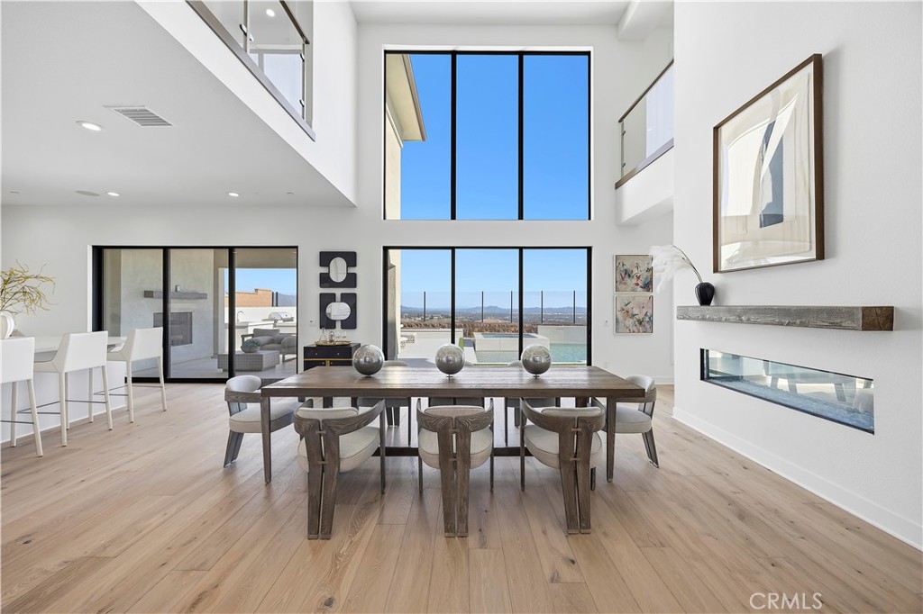 20138 Marlow Lane Porter Ranch, CA 91326 - Photo 3 of 39 a dining room with wooden floor a glass table and chairs