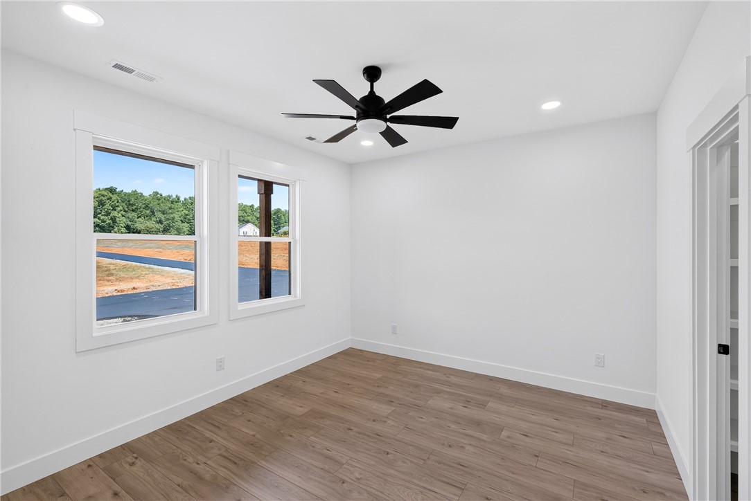 416 Blume Road Anderson, SC 29625 - Photo 17 of 29 A well-lit room offers hardwood flooring and ample window views of the surrounding landscape.