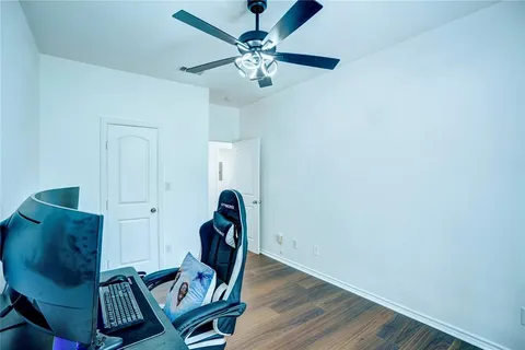 a view of a workspace with furniture and a chandelier fan