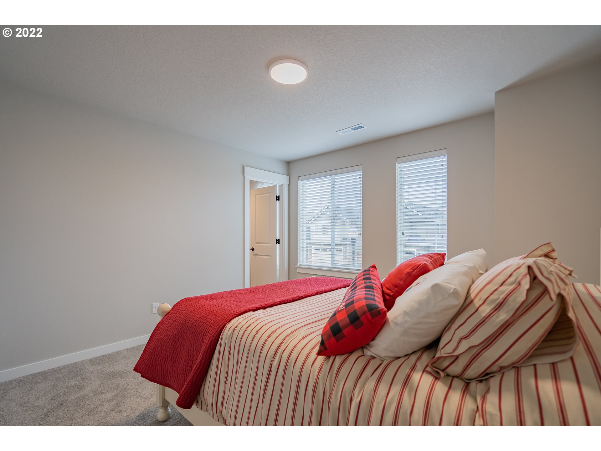 7143 South 13th Street Ridgefield, WA 98642 - Photo 26 of 31 a bedroom with a bed and a window