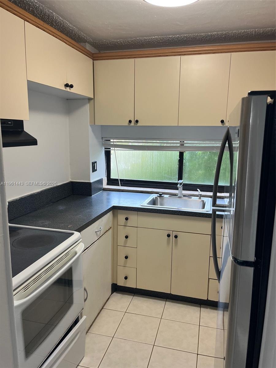 17021 North Bay Road, Unit 508 Sunny Isles Beach, FL 33160 - Photo 14 of 22 a kitchen with stainless steel appliances a sink and a refrigerator