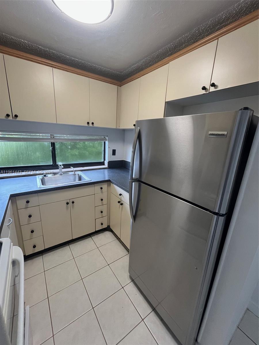 17021 North Bay Road, Unit 508 Sunny Isles Beach, FL 33160 - Photo 15 of 22 a kitchen with stainless steel appliances a refrigerator sink and cabinets