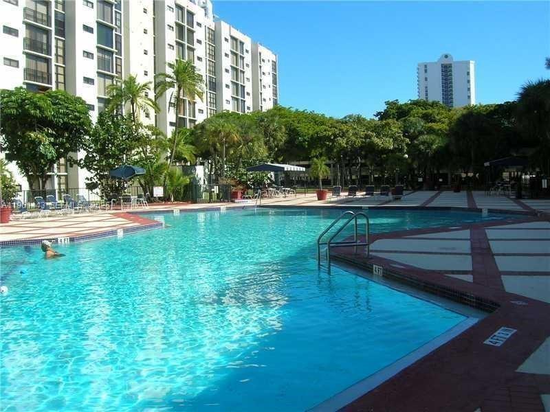 17021 North Bay Road, Unit 508 Sunny Isles Beach, FL 33160 - Photo 6 of 22 a view of a swimming pool with a garden