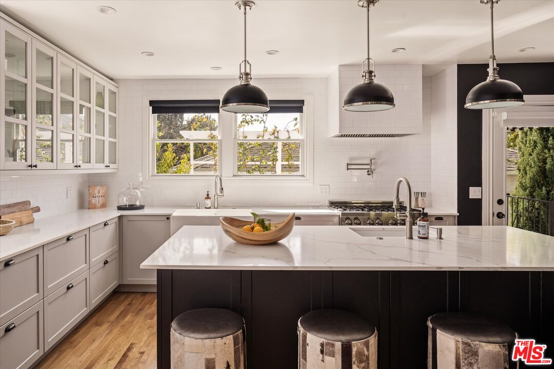1735 Idlewood Road Glendale, CA 91202 - Photo 11 of 64 a kitchen with a sink a window and chairs