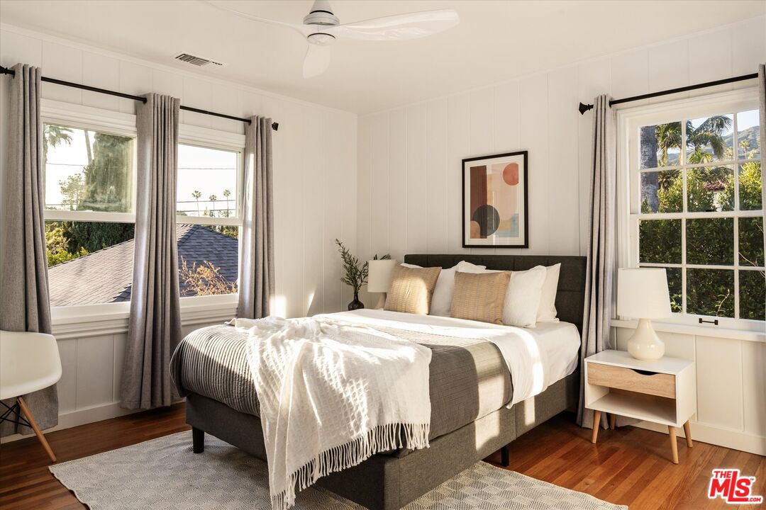 1735 Idlewood Road Glendale, CA 91202 - Photo 20 of 64 a bedroom with a bed wooden floor and a large window