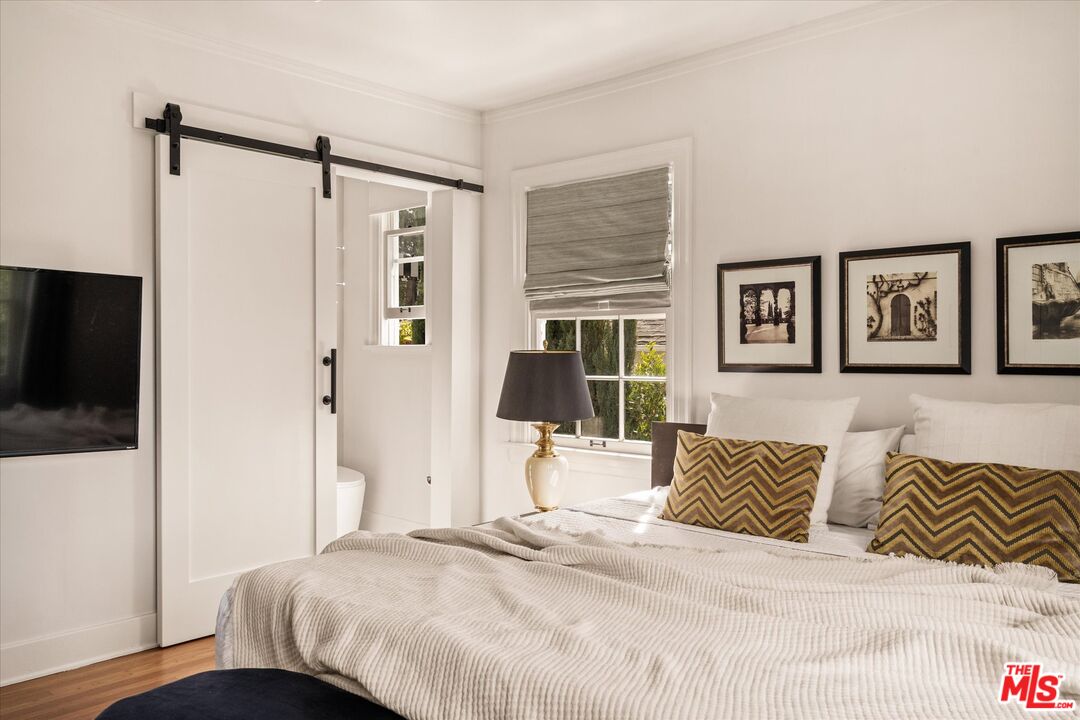 1735 Idlewood Road Glendale, CA 91202 - Photo 23 of 64 a bedroom with a bed and wooden floor