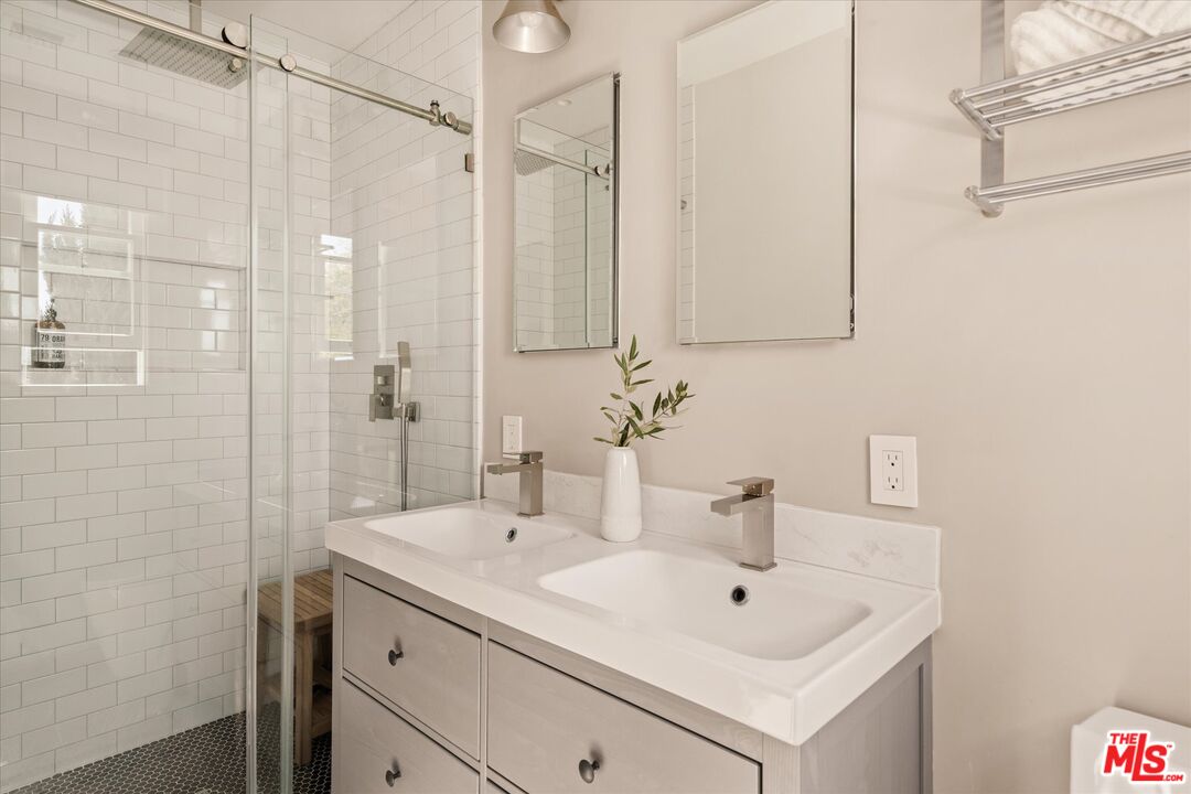 1735 Idlewood Road Glendale, CA 91202 - Photo 24 of 64 a bathroom with a sink a mirror and shower