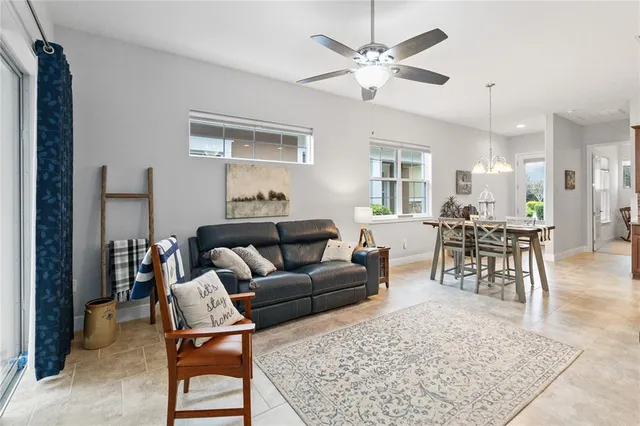 a living room with furniture a window and a flat screen tv
