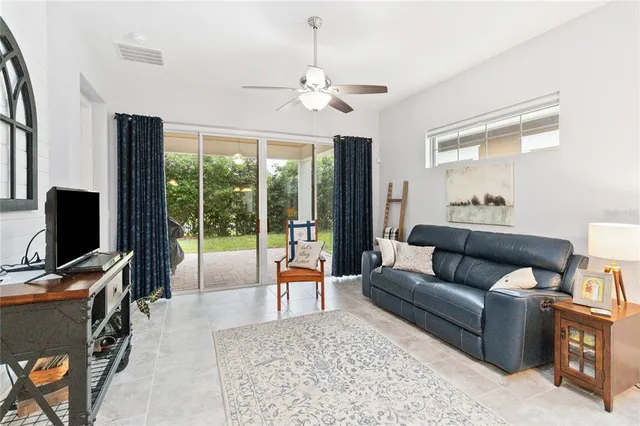 a living room with furniture a window and a chandelier