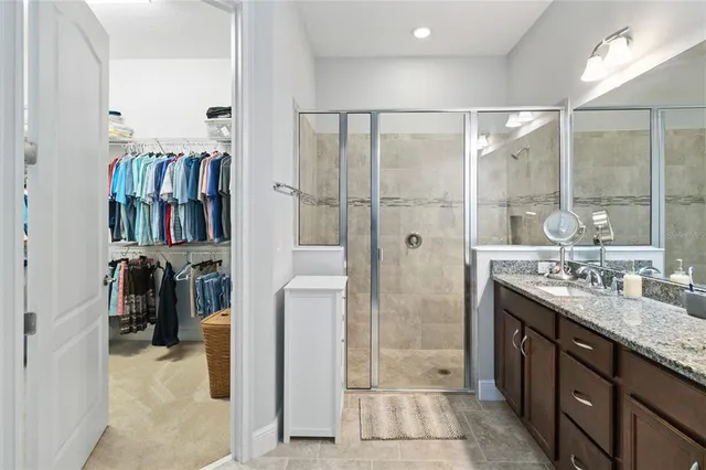 a view of walk in closet with clothes