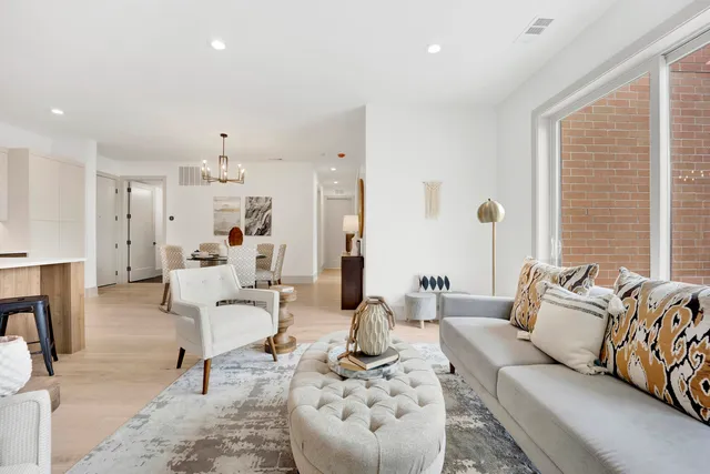 a living room with furniture and kitchen view
