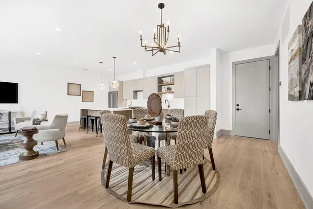 a view of a dining room with furniture and wooden floor