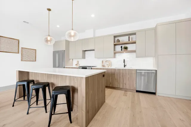 a kitchen with stainless steel appliances a sink stove and cabinets