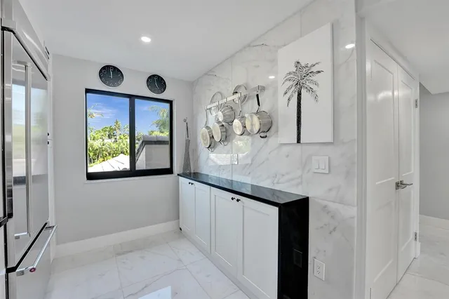 a view of kitchen and dining area with a sink wooden floor