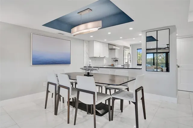 a living room with furniture and large windows