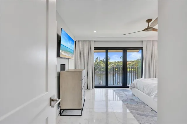 a living room with furniture and a ceiling fan