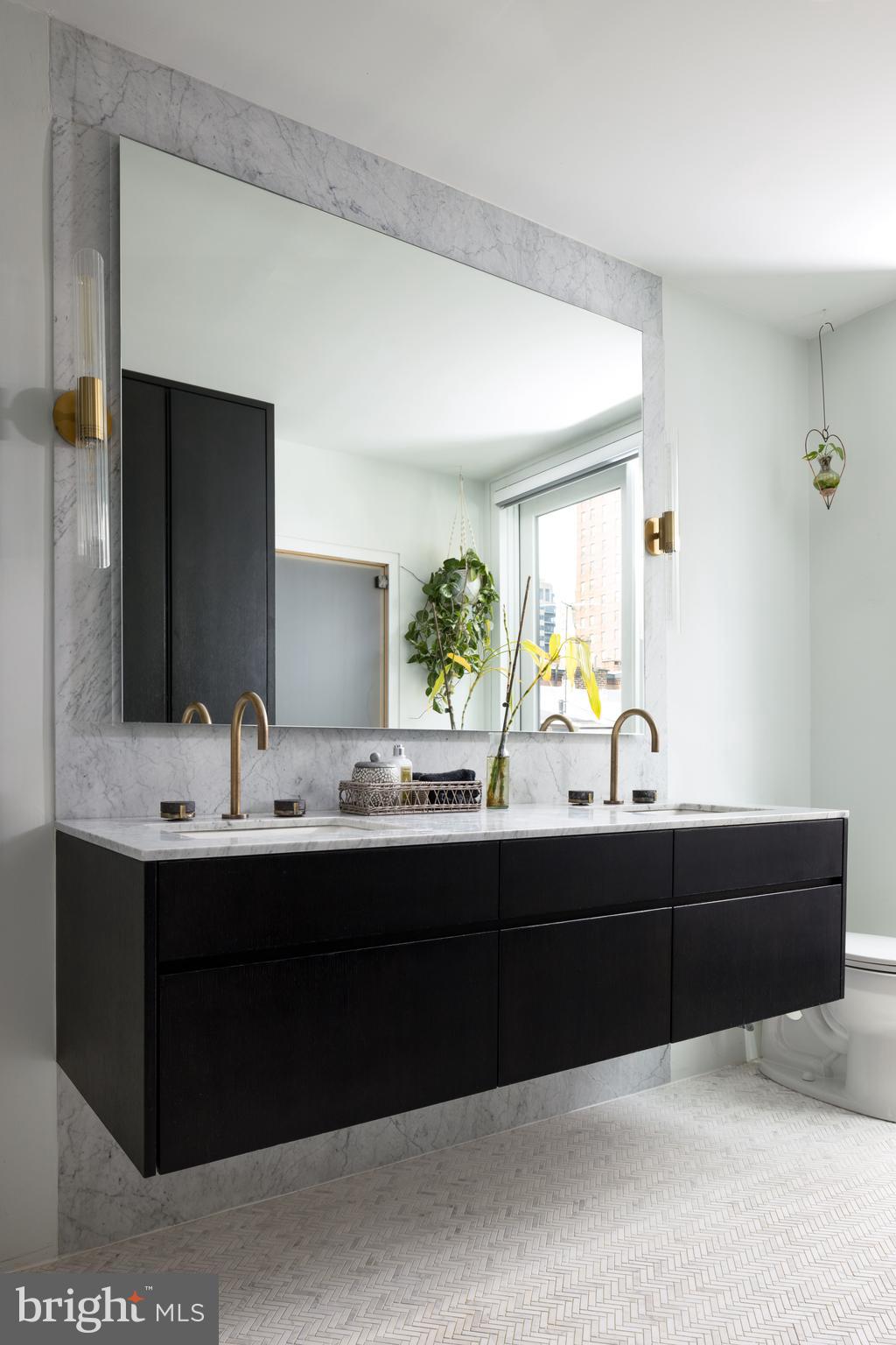 1727 Delancey Place Philadelphia, PA 19103 - Photo 17 of 35 a bathroom with a sink and a mirror