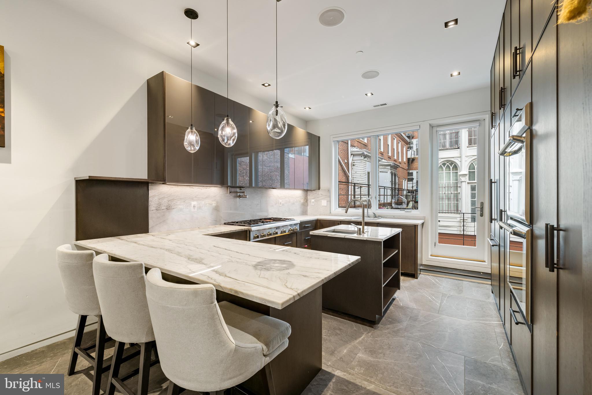 1727 Delancey Place Philadelphia, PA 19103 - Photo 6 of 35 a large kitchen with a table and chairs