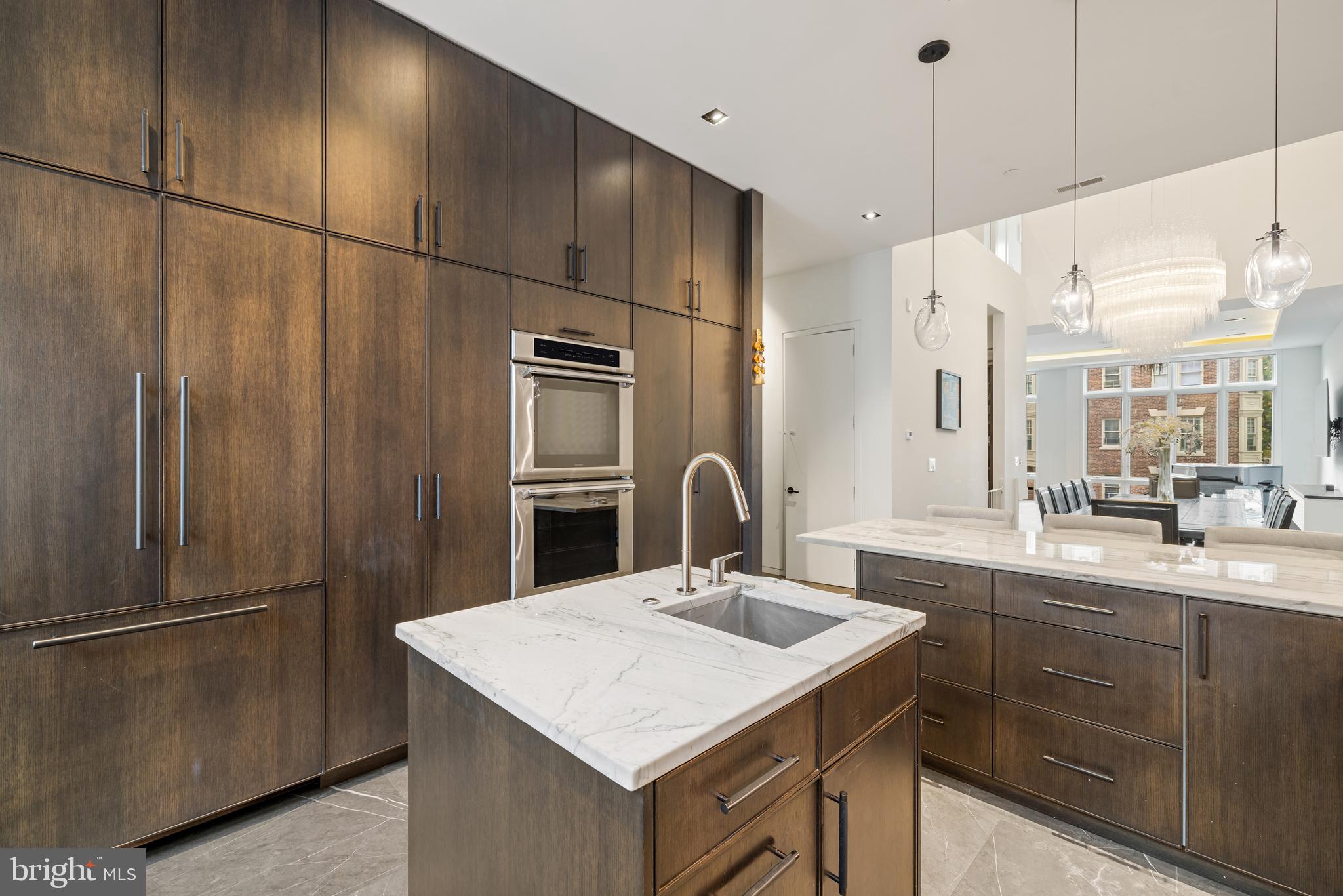 1727 Delancey Place Philadelphia, PA 19103 - Photo 7 of 35 a kitchen with a sink a refrigerator and cabinets