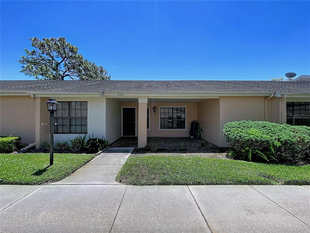 9319 Trowbridge Court New Port Richey, FL 34655 - Photo 63 of 78 front view of a house with a yard