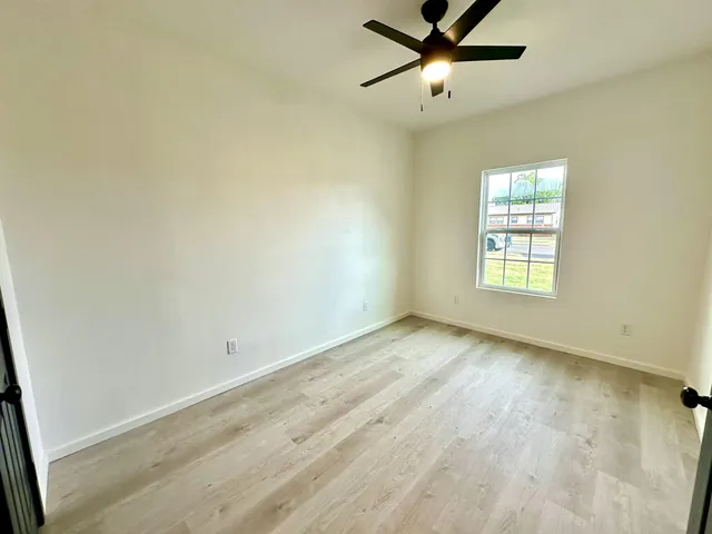 wooden floor in an empty room with a window