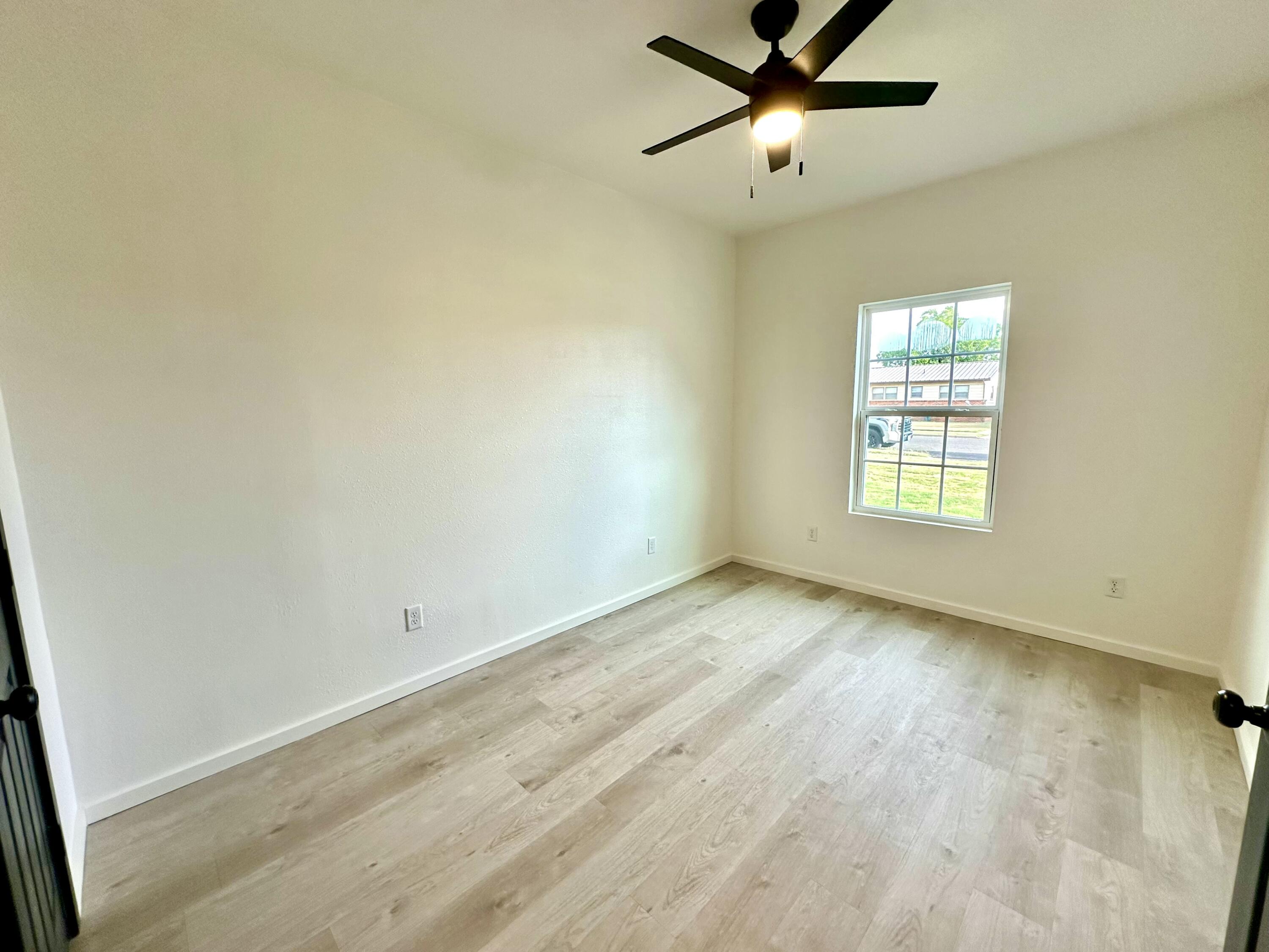 2617 47th Street Lubbock, TX 79413 - Photo 11 of 12 wooden floor in an empty room with a window